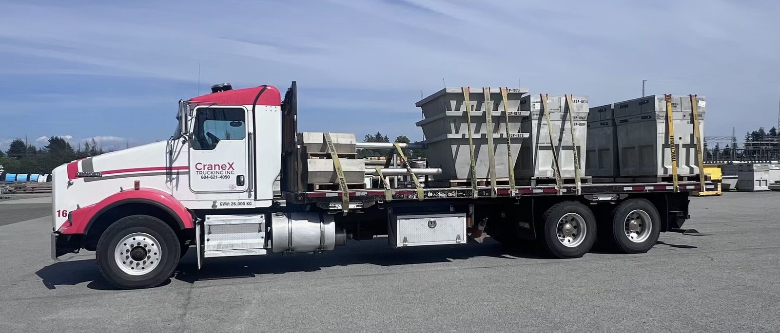 CraneX truck hauling precast concrete product on a flat deck