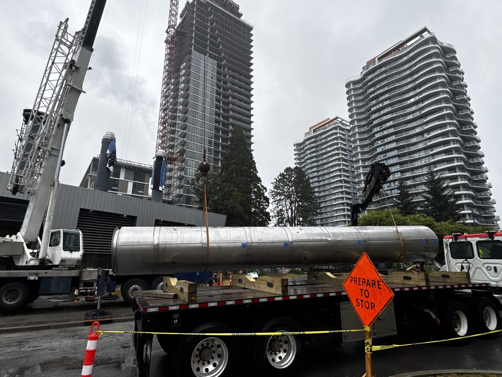 Two picker trucks performing a tandem lift on a subcontracted job