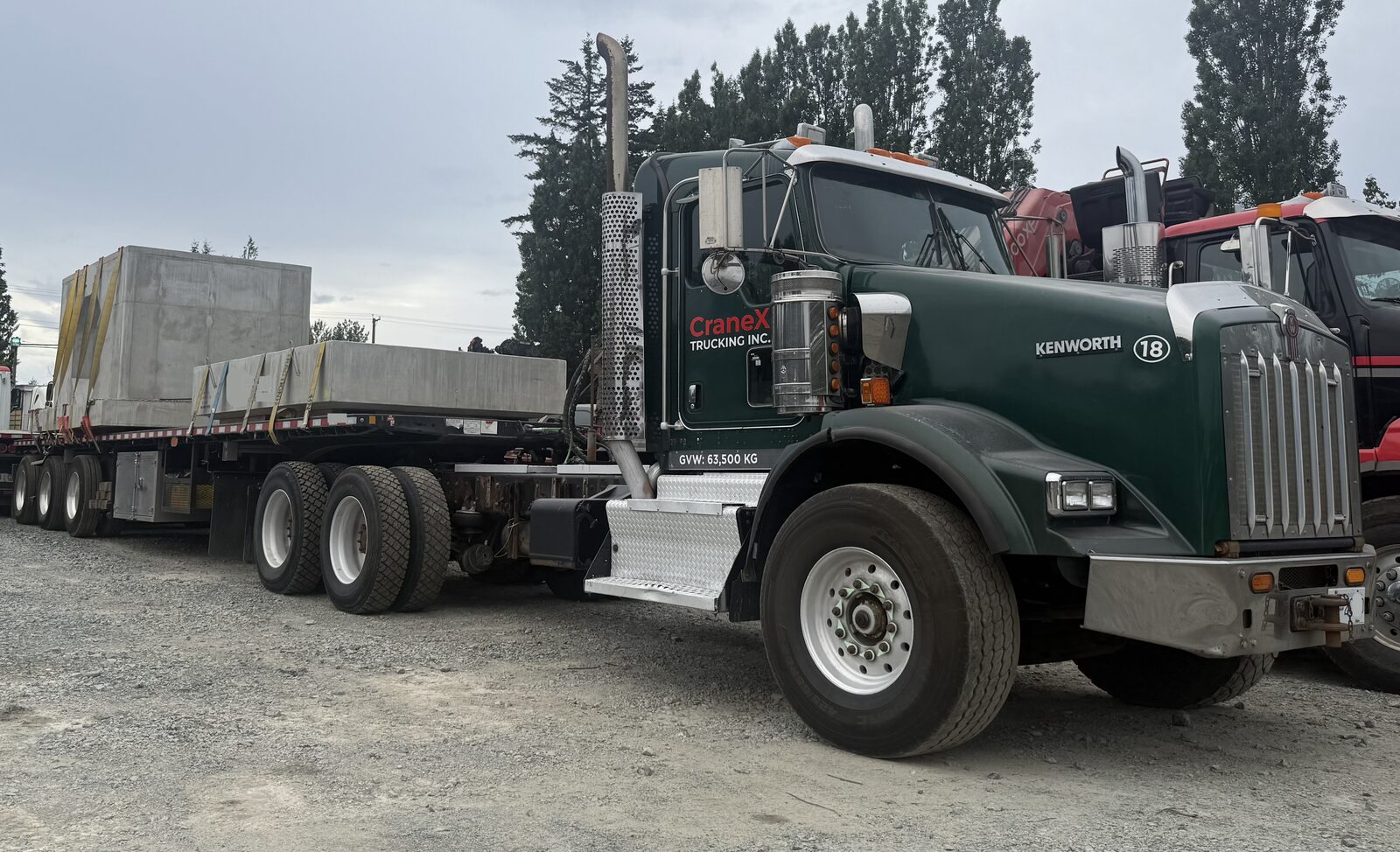 CraneX tractor and trailer hauling a heavy load on a highway