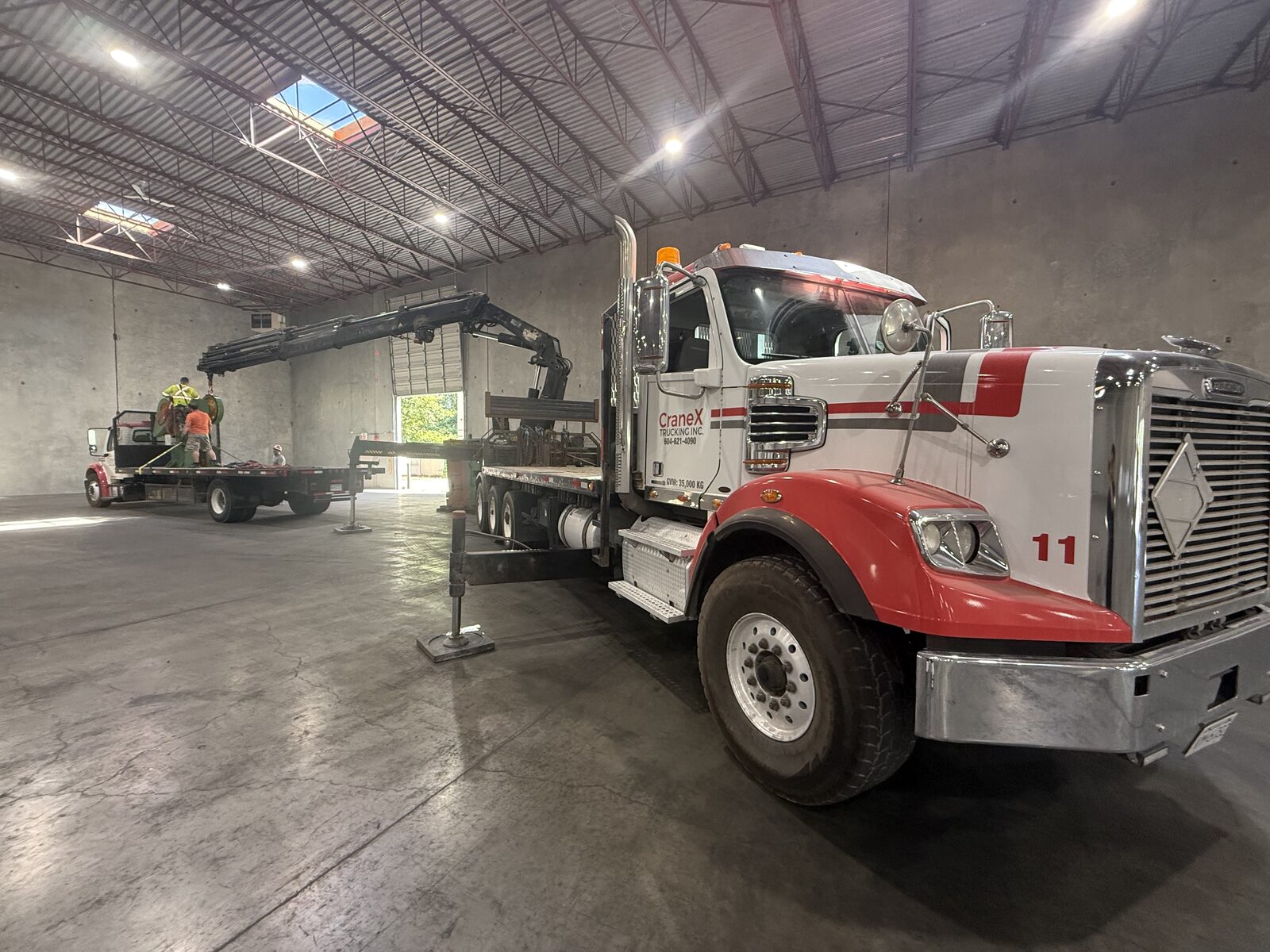 CraneX truck inside an industrial building during a shop machinery move